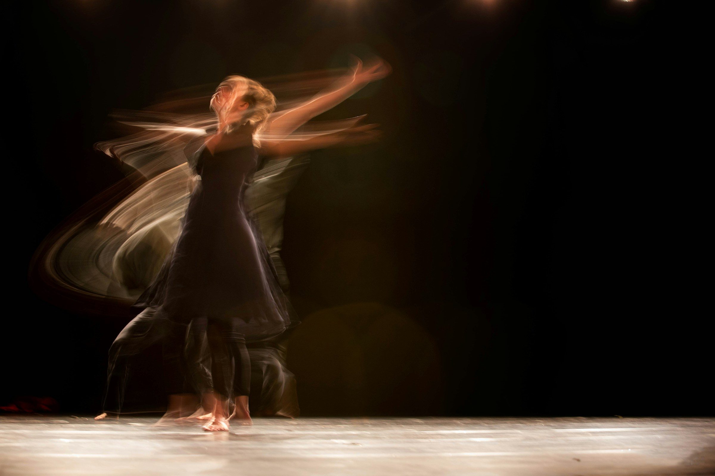 A dancer moving through long-exposure light